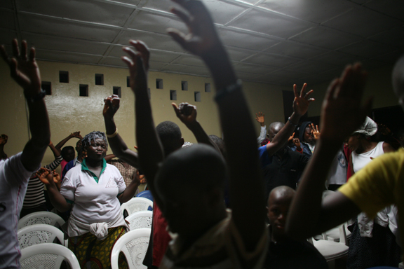 Members of the Pillar of Fire Church raise their hands in praise on New Year's Eve, known as Watch Night, on the grounds of the Firestone Natural Rubber Company in Harbel, Monrovia, on Wednesday, Dec. 31, 2014. Reverend Luther Tarpeh leads the four-hour service. His sister, a healthcare worker, died of Ebola last month. His next door neighbor, a “big medical doctor,” died of Ebola as well, he said.